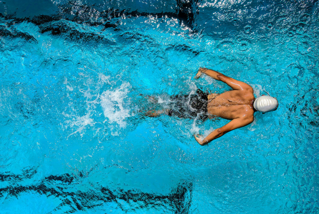 Person swimming on body of water