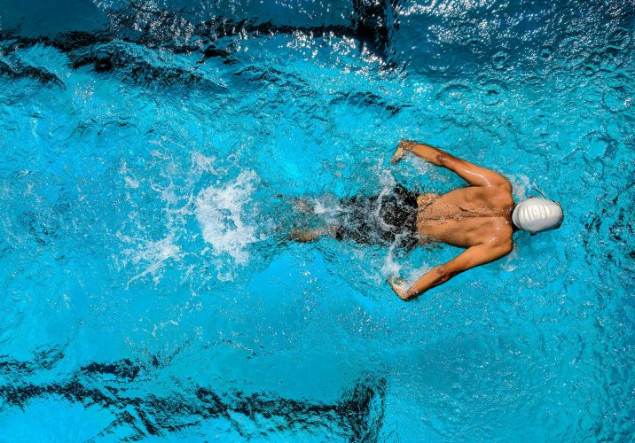 Person swimming on body of water